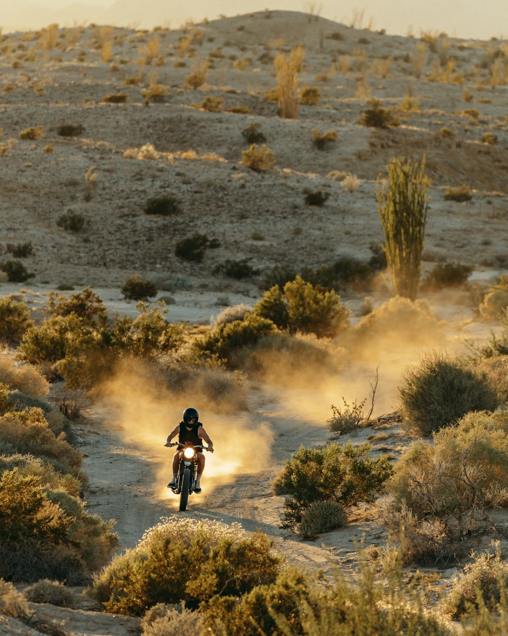 a person riding a dirt bike on a dirt road