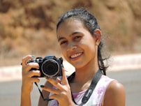 a girl taking a picture with a camera