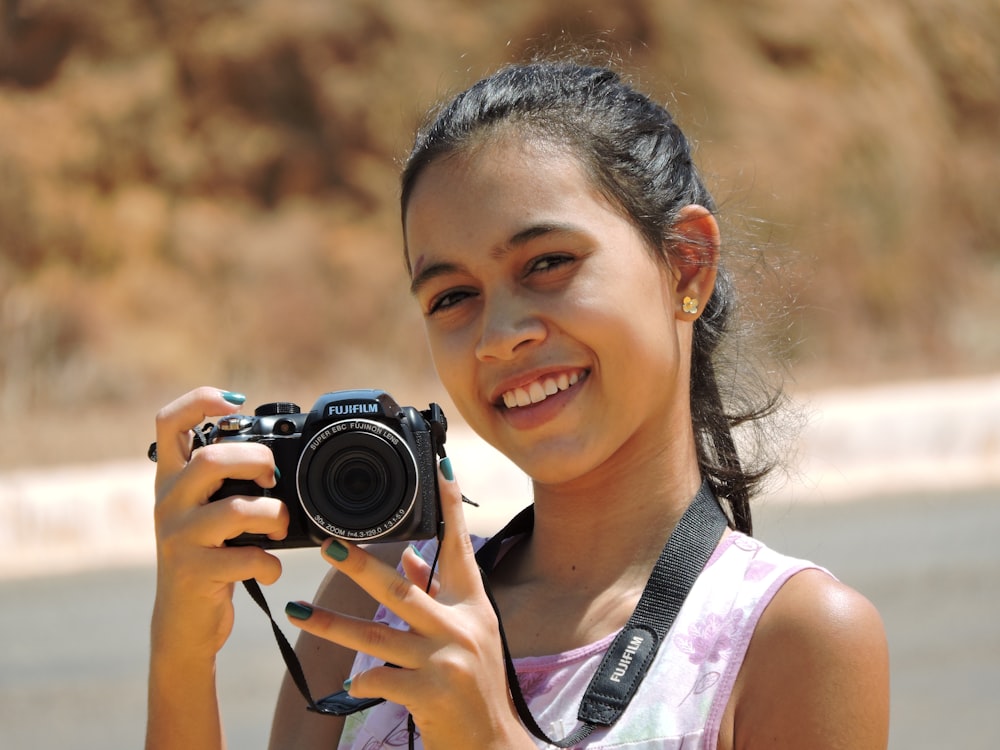 a girl taking a picture with a camera