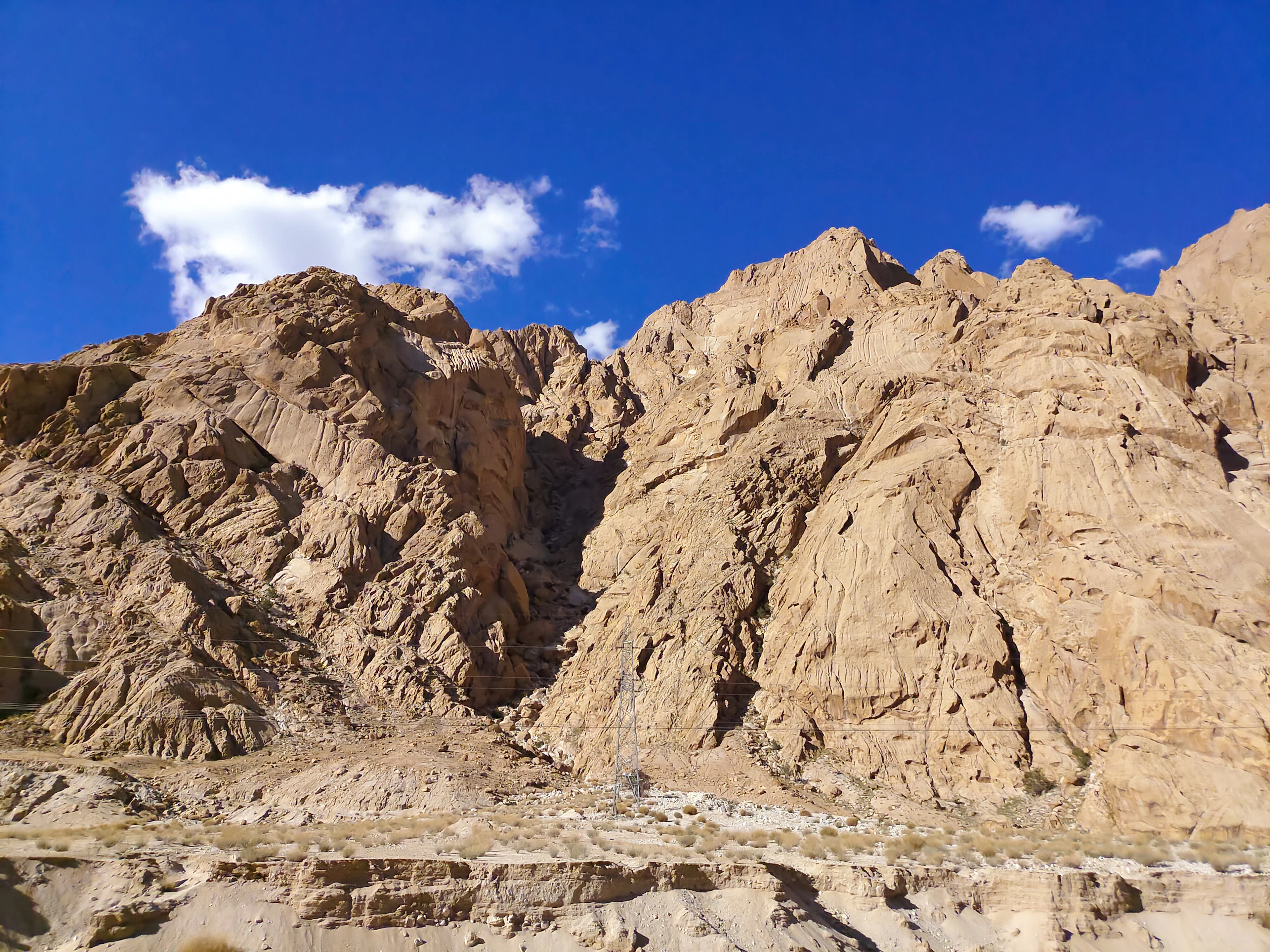 A rocky mountain under a bright blue sky