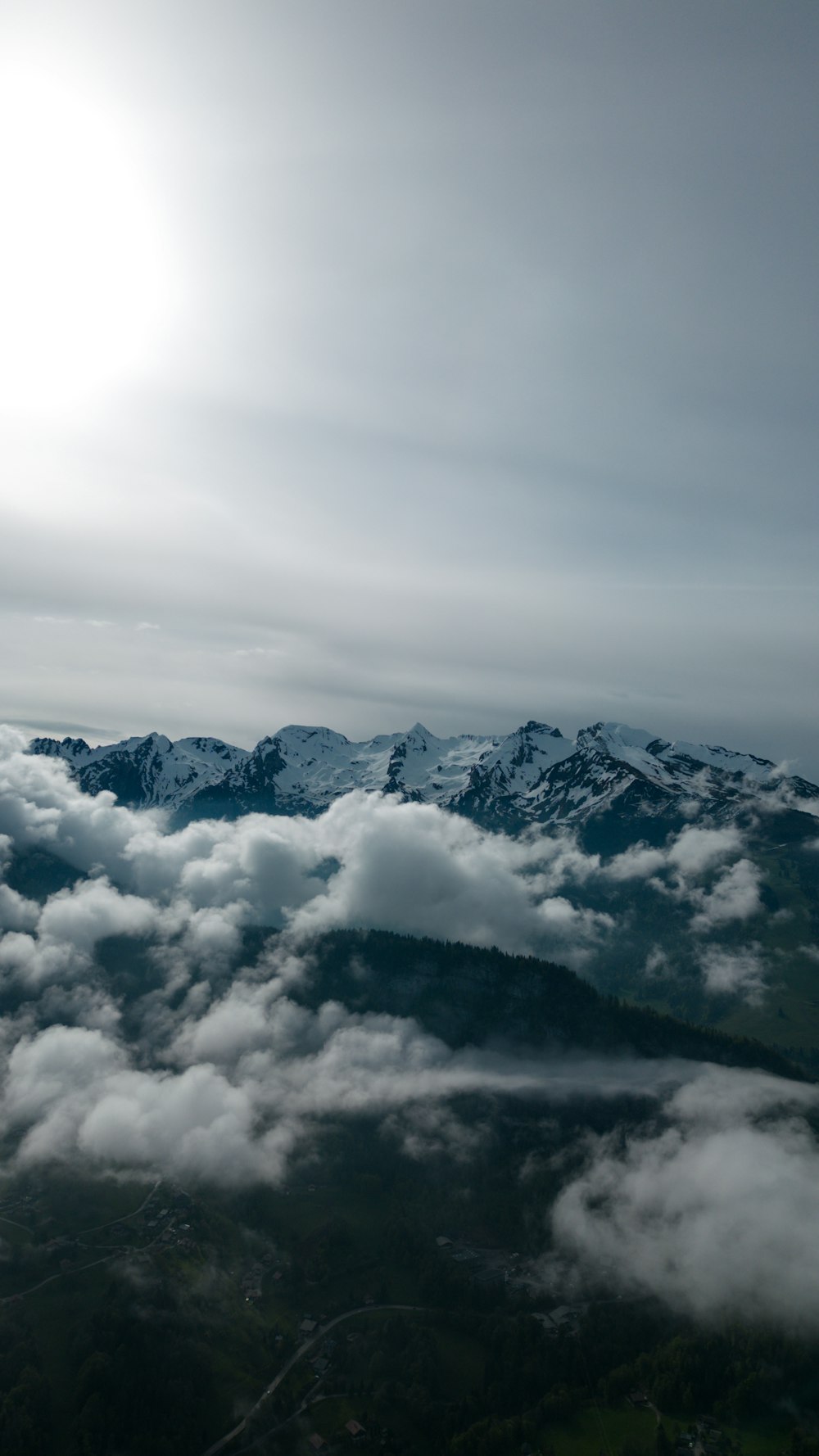a view of the mountains and clouds from an airplane