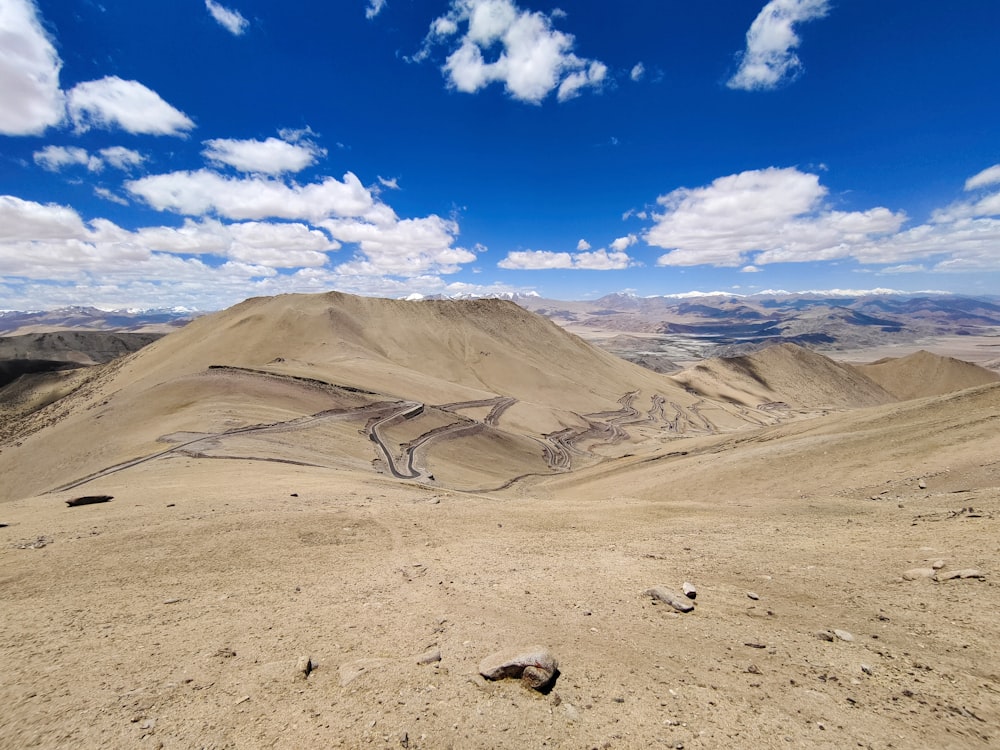 a view of a mountain range from the top of a hill