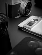 Retro film camera juxtaposed with digital AI art screens.
