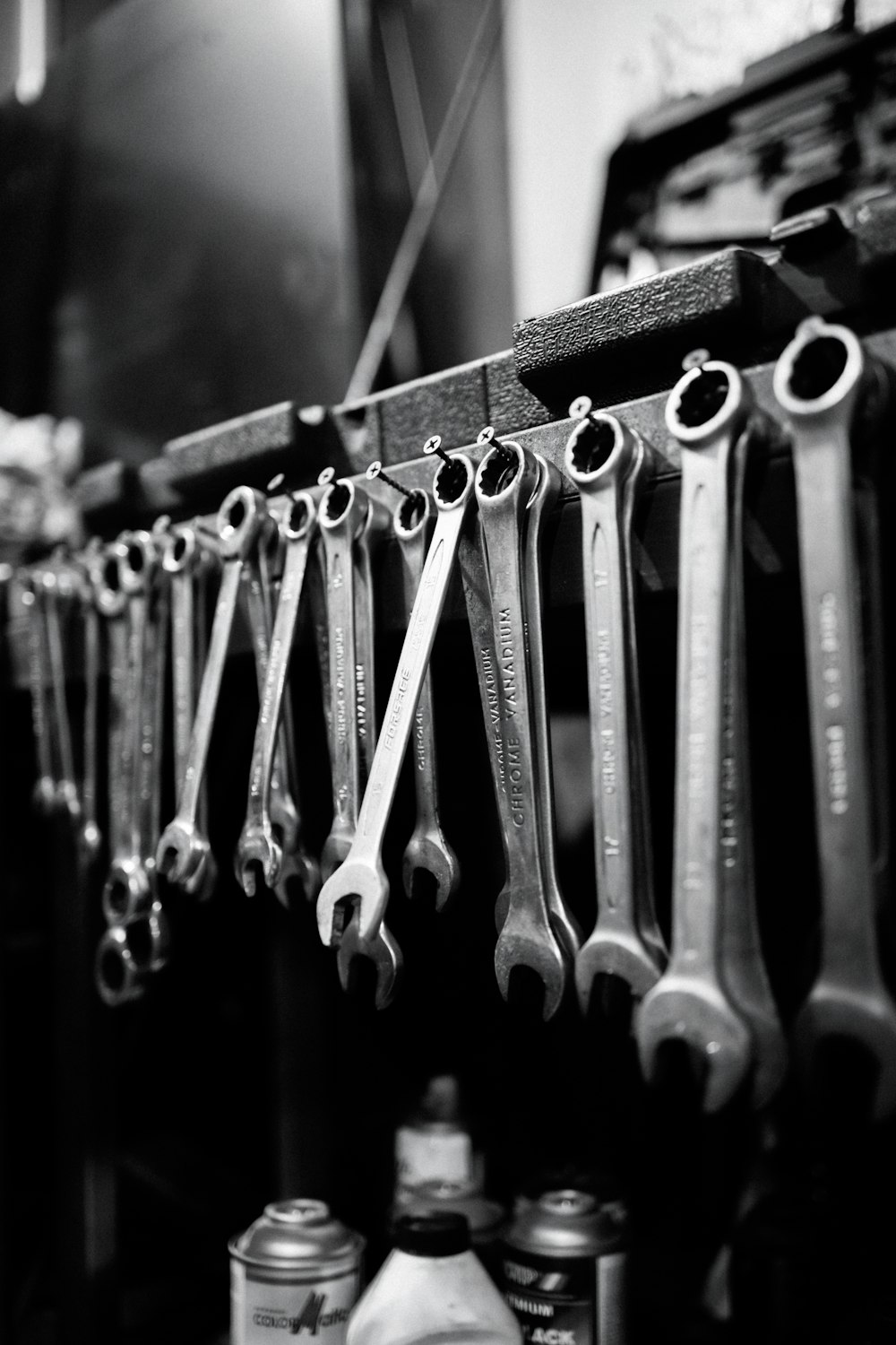 a bunch of wrenches are hanging on a rack