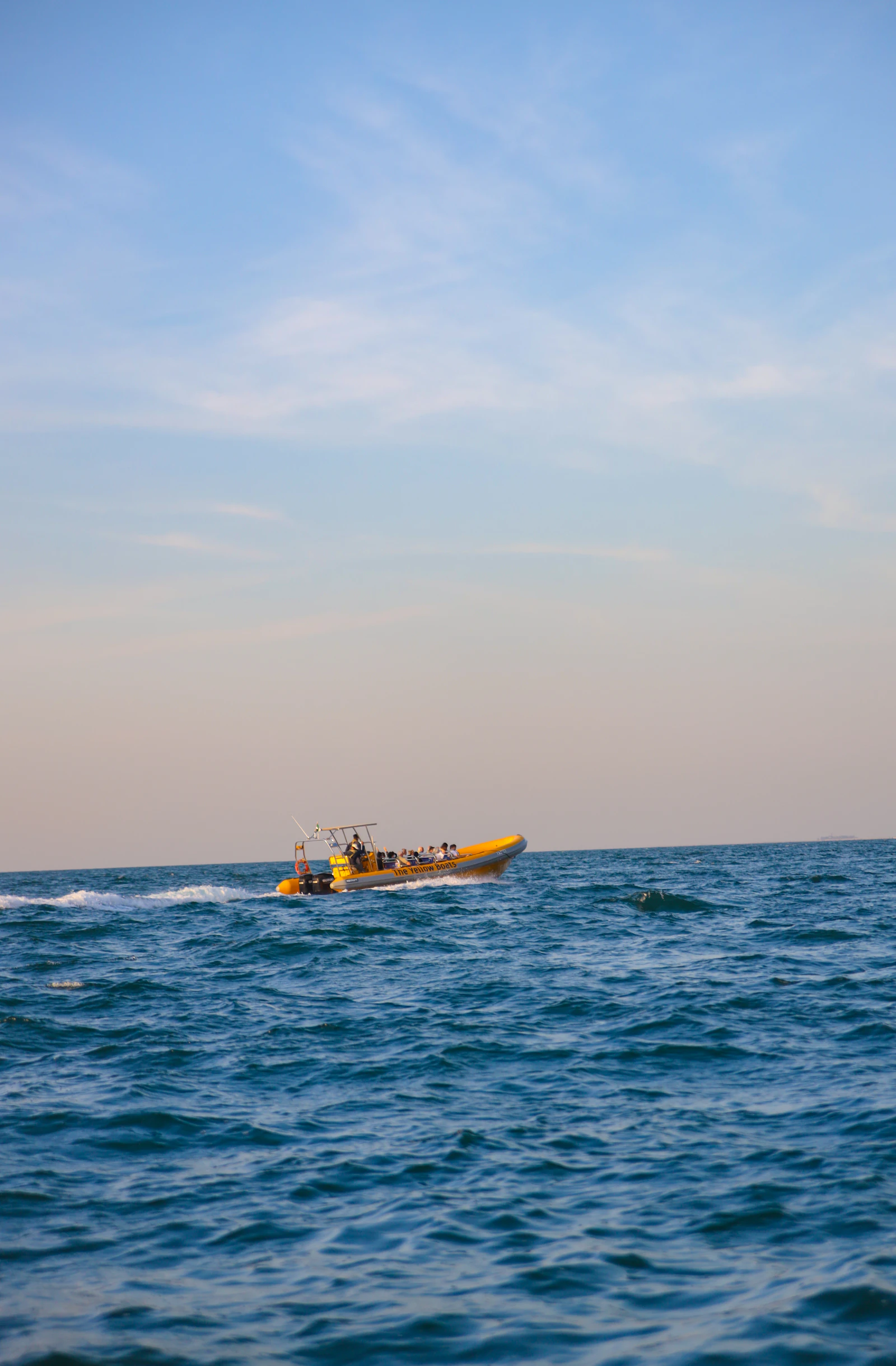 The Yellow Boats RIB carrying passengers at speed across the sea off Dubai