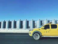 A Novoross Corp truck navigating through a busy regional distribution center under a clear blue sky.