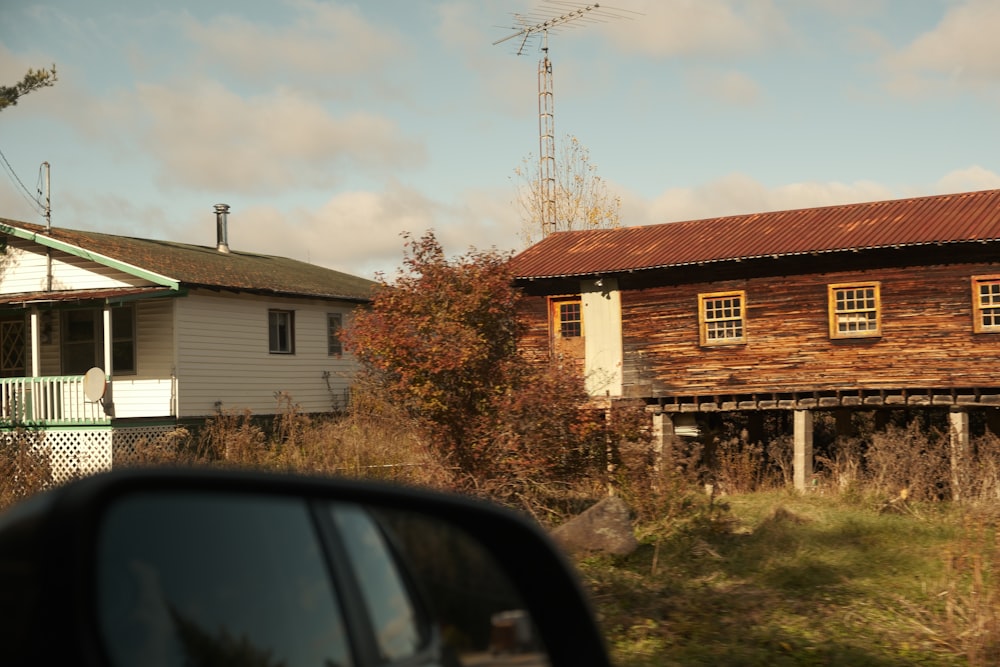 a house with a red tin roof and a brown tin roof