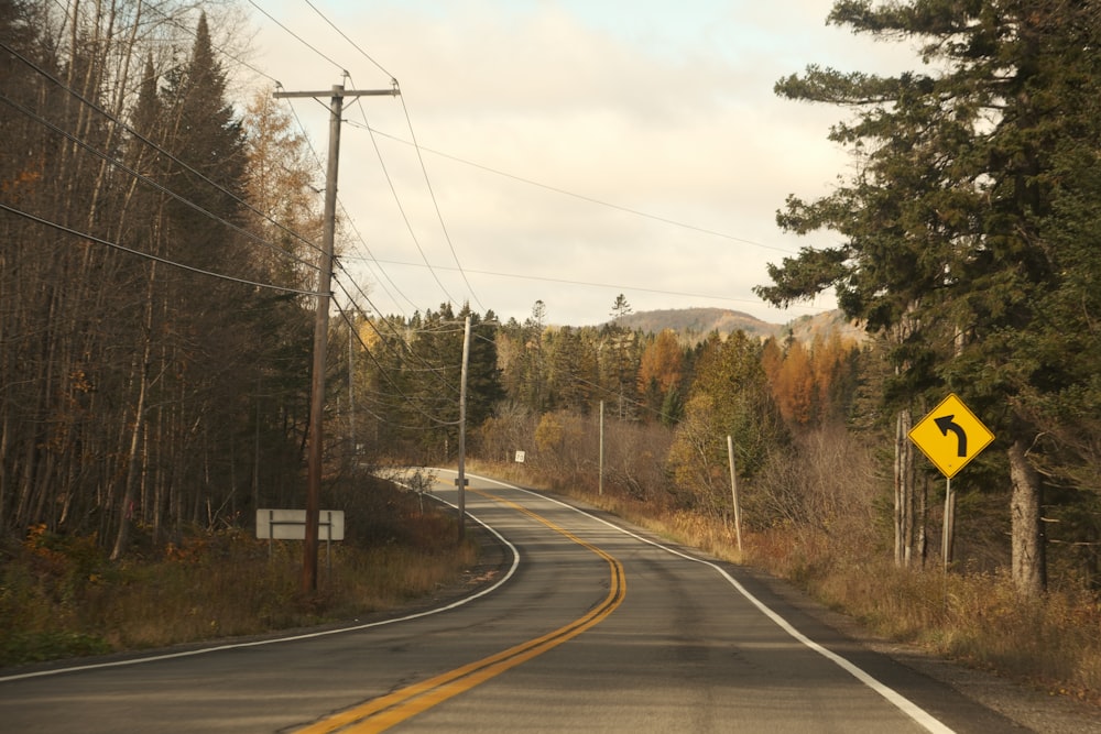 a road with a yellow sign on the side of it