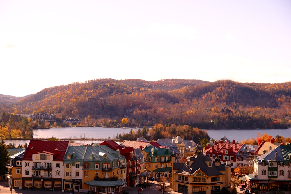 a scenic view of a town with mountains in the background