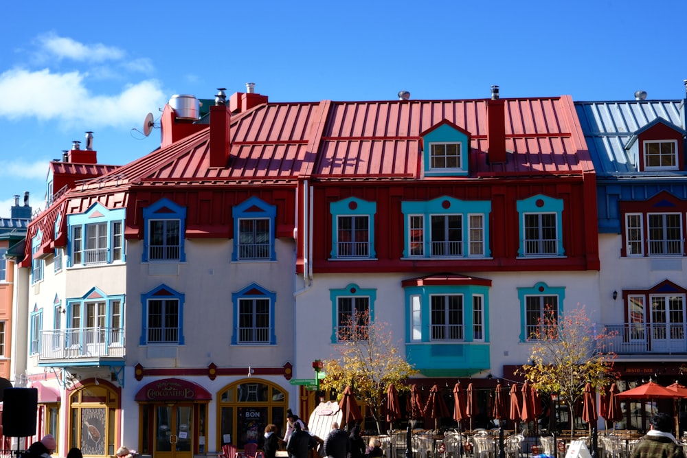 a group of people standing outside of a multi - colored building