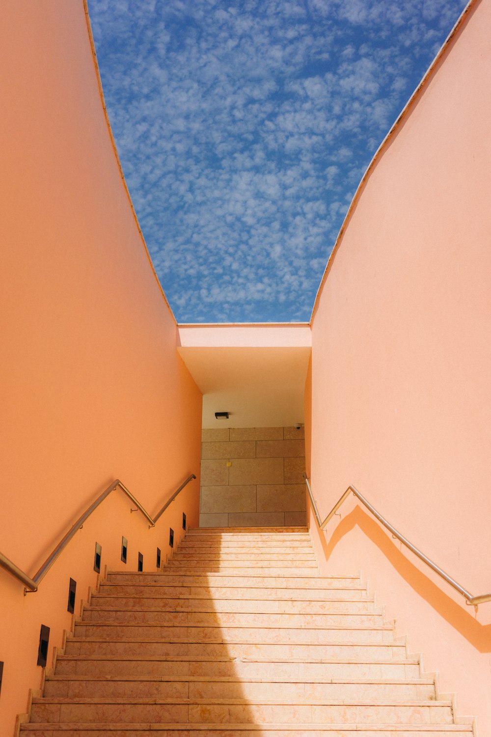 a staircase leading up to a sky filled with clouds