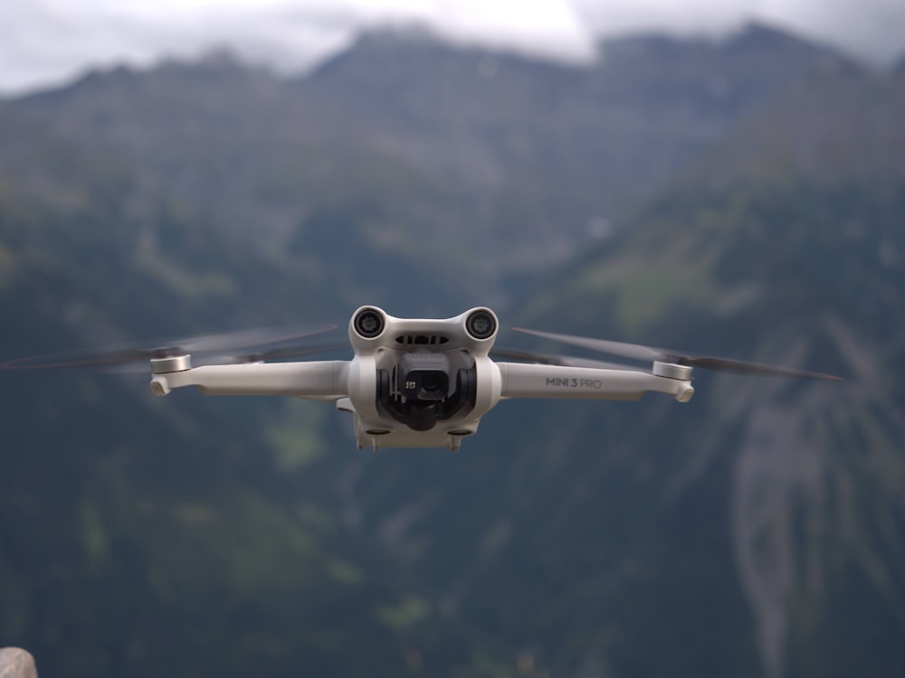 a close up of a small white airplane flying in the sky