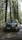 a car parked on the side of the road in the woods
