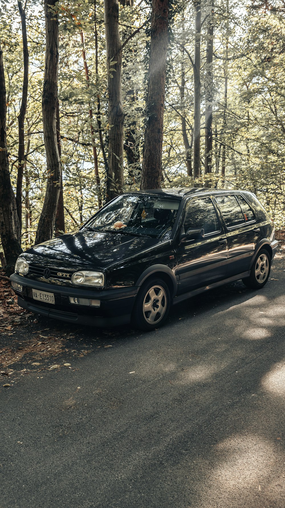 a black car parked on the side of a road