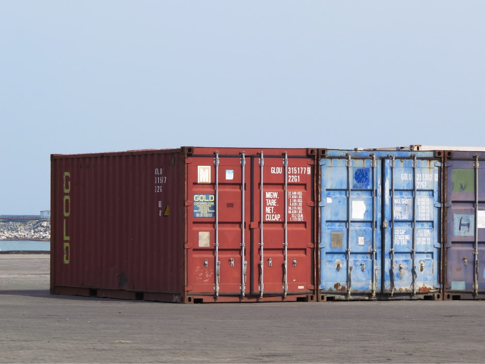 a couple of red and blue containers sitting next to each other