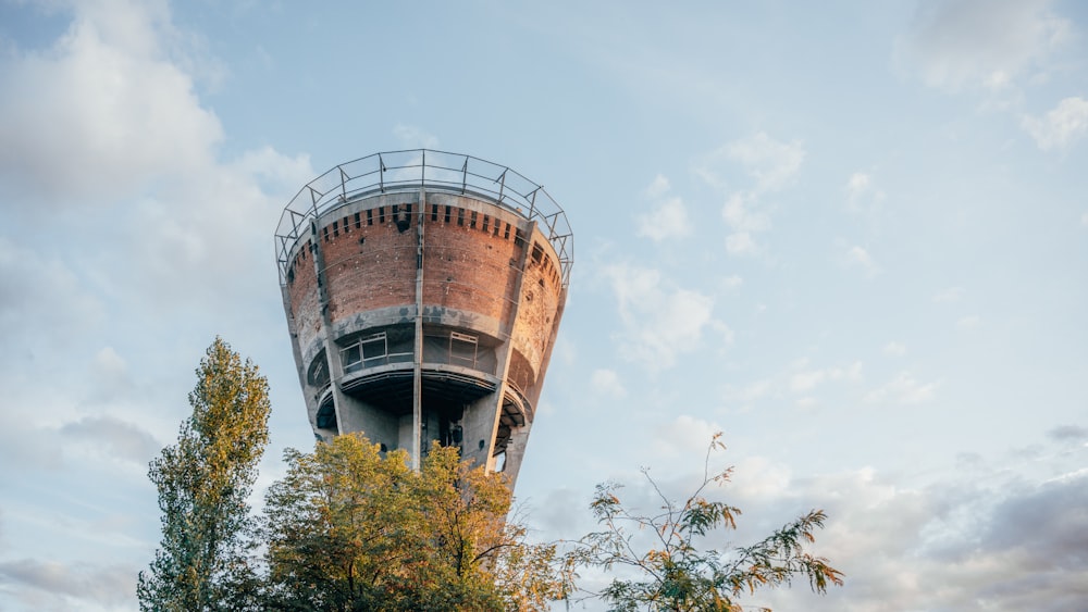 a tall tower with a metal railing on top of it