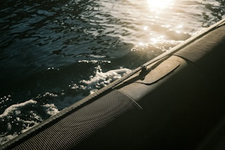 Close-up of a polished boat hull shining under the sun.