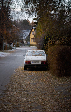 a white car parked on the side of a road
