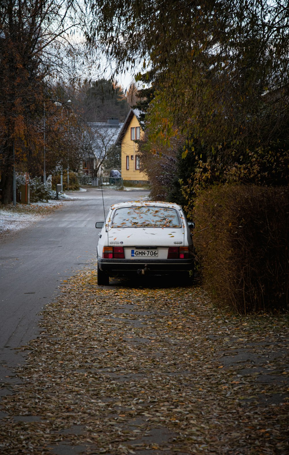 a white car parked on the side of a road