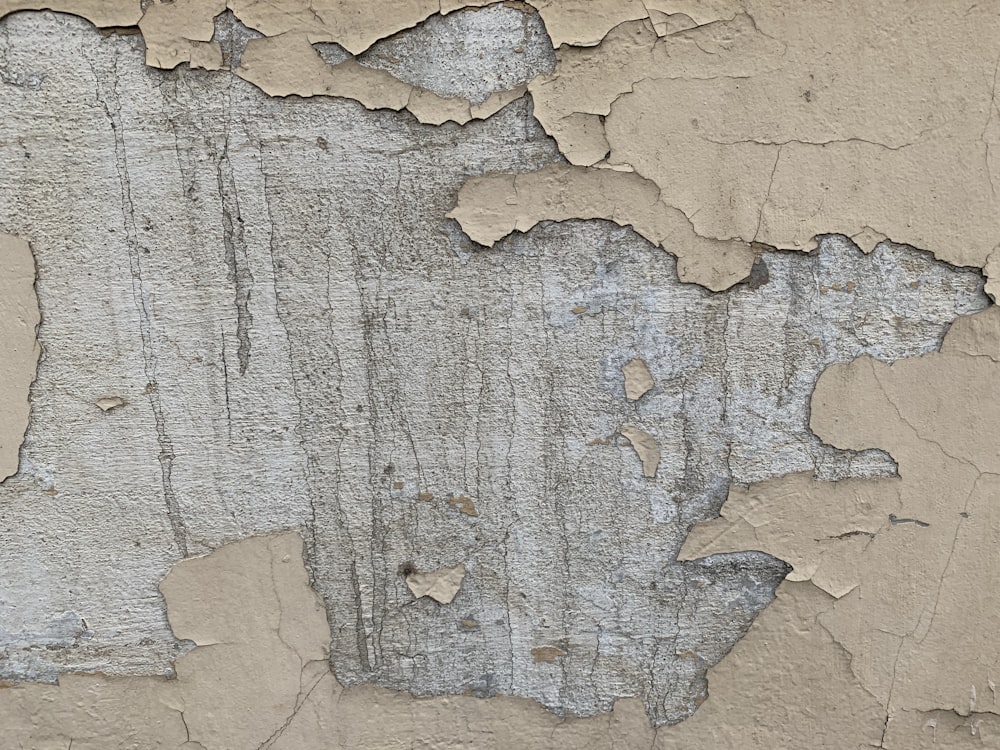 a close up of peeling paint on a wall