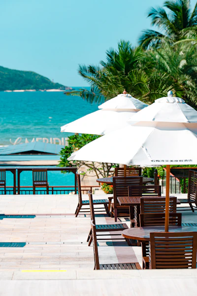 tables and chairs with umbrellas on the beach