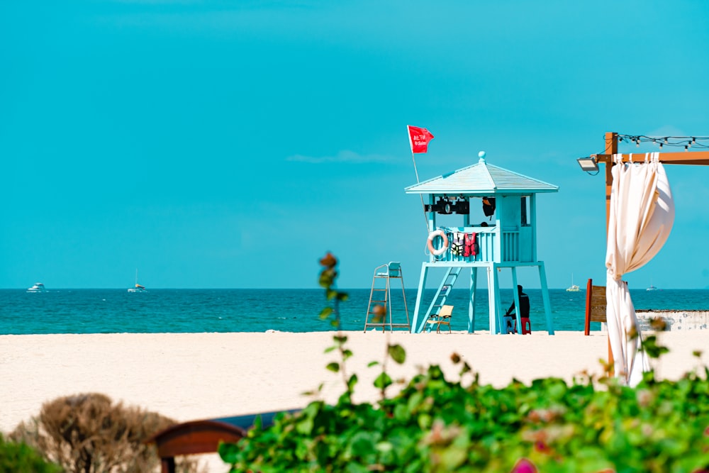 a lifeguard tower on a beach next to the ocean