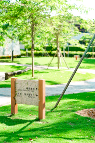 A sleek, modern signpost marking the entrance to a premium land estate.