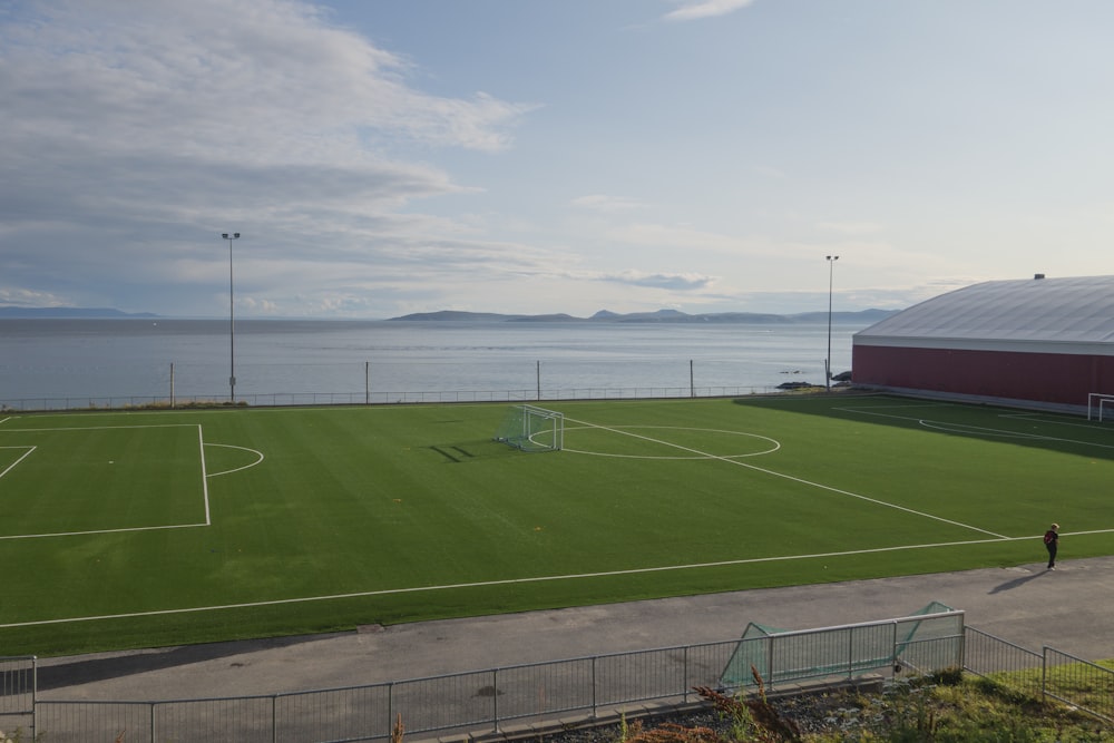 a soccer field next to a large body of water