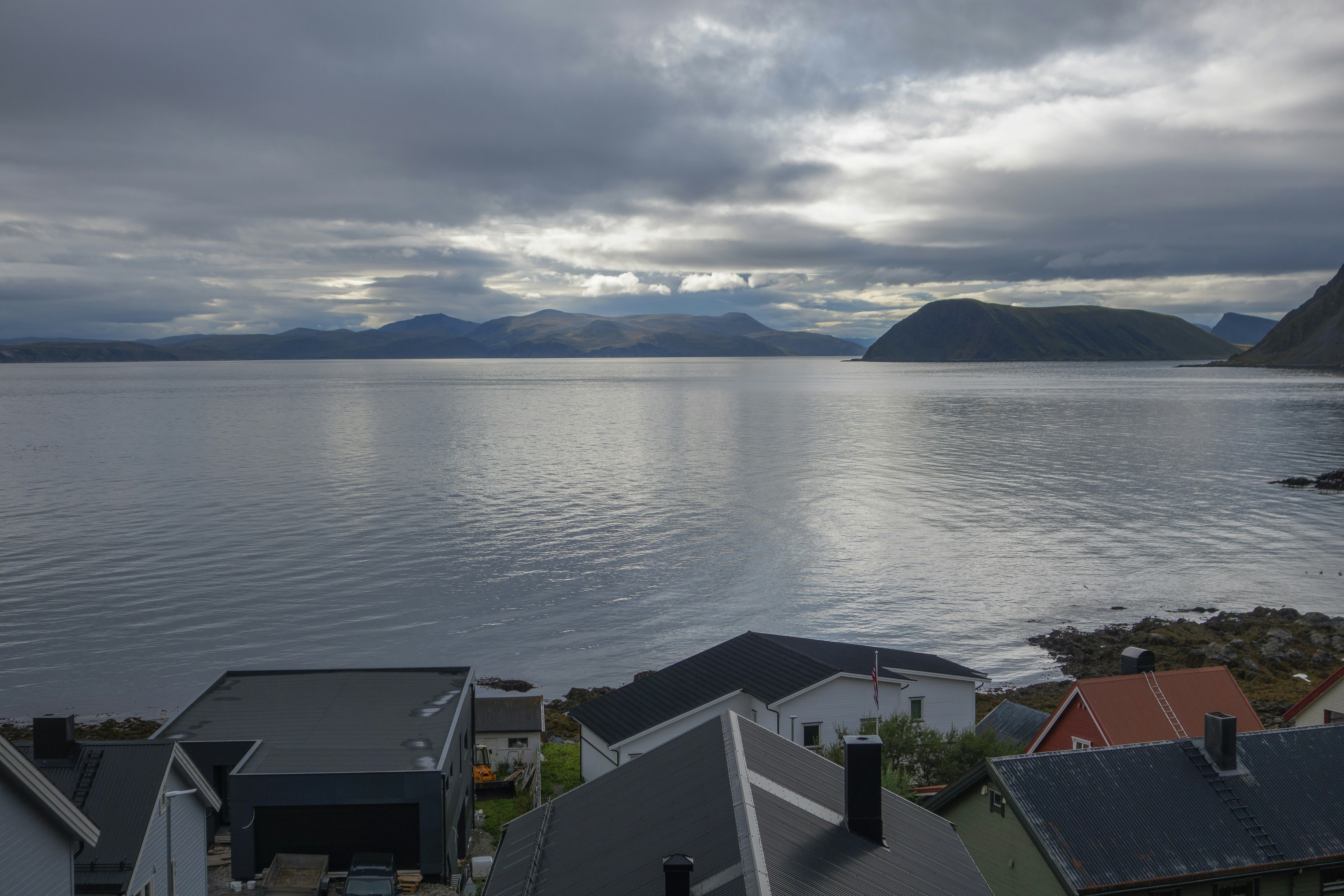 a view of a body of water with houses in the foreground