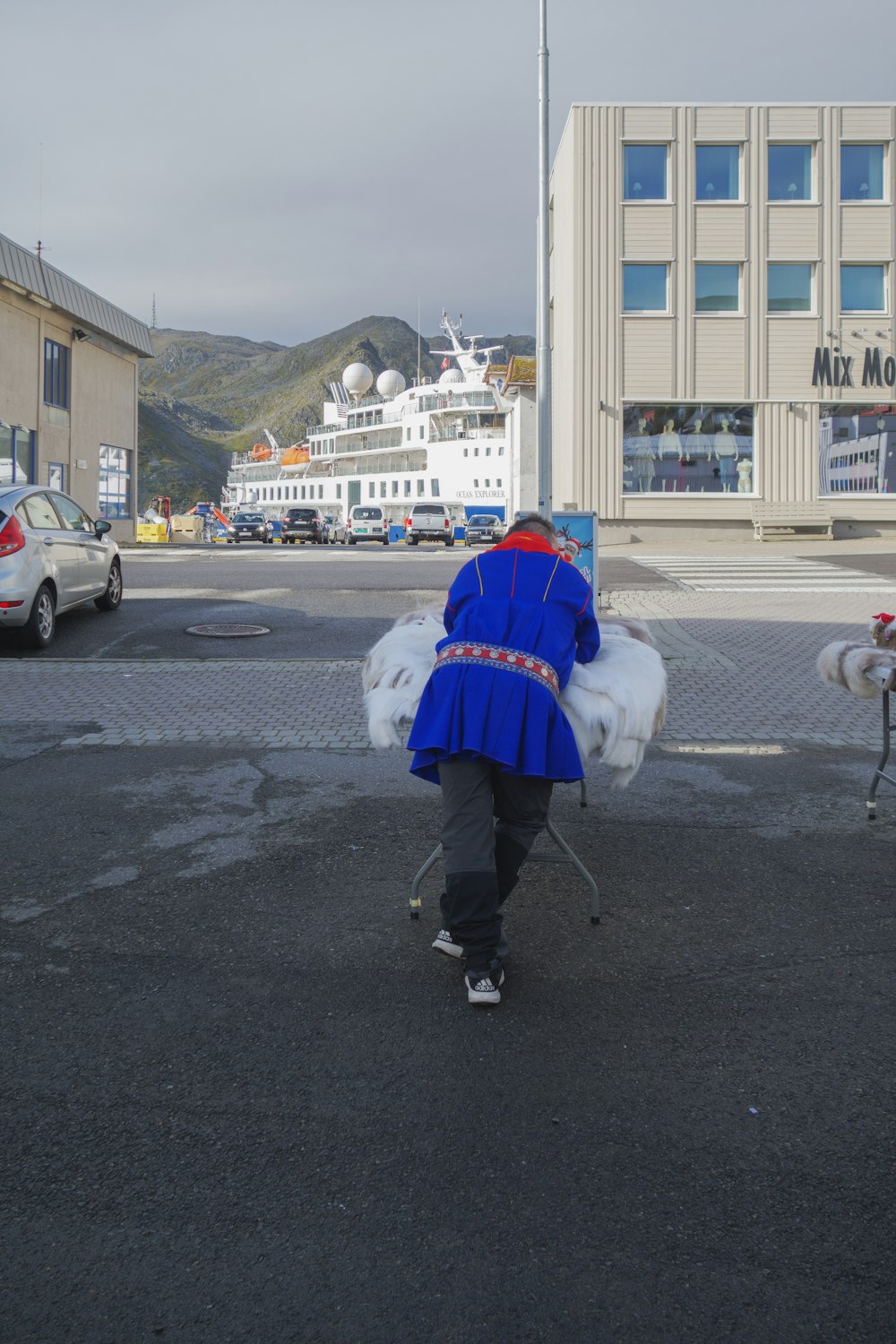 a person walking down a street carrying bags