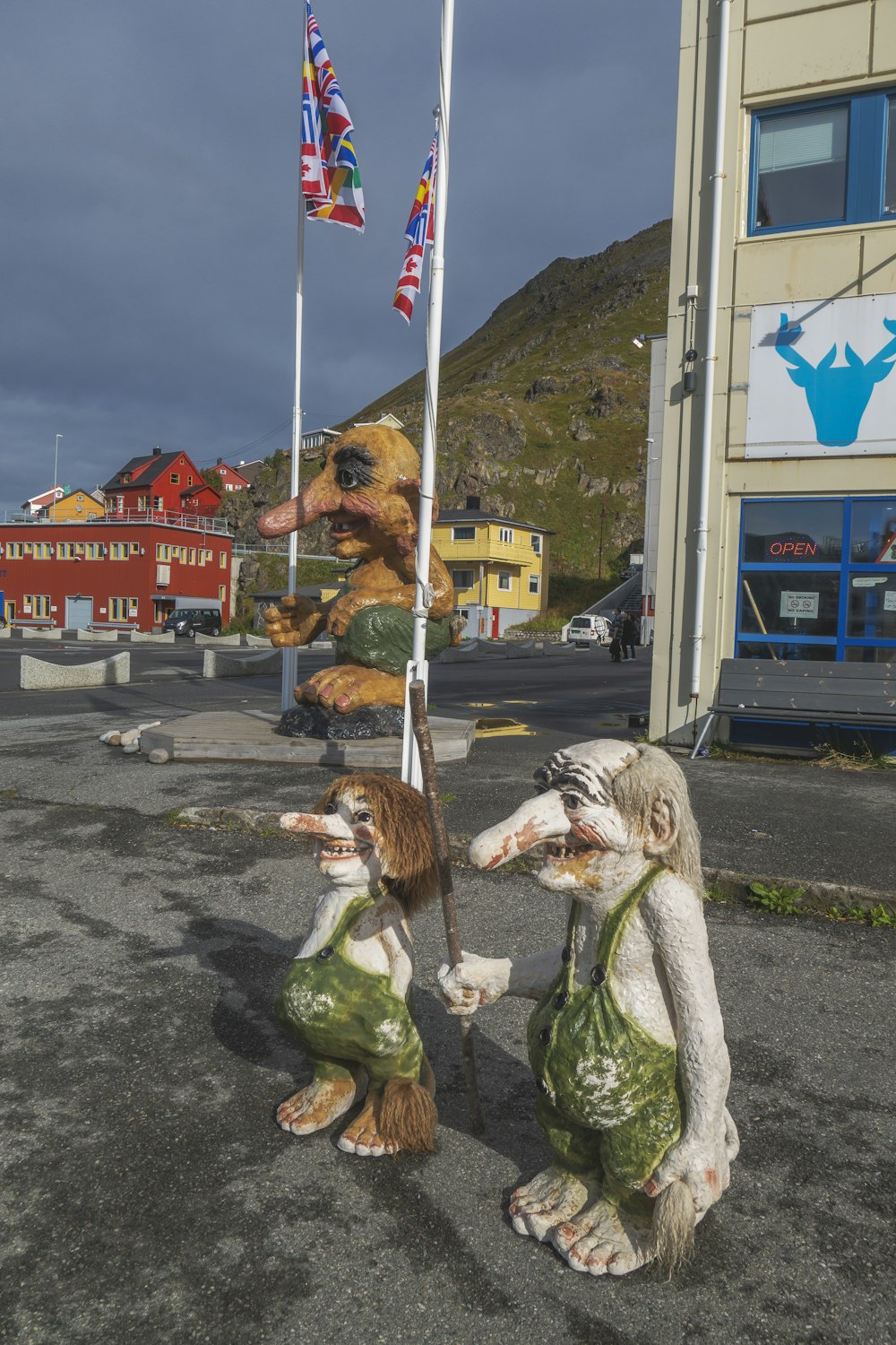 a couple of statues of animals holding flags