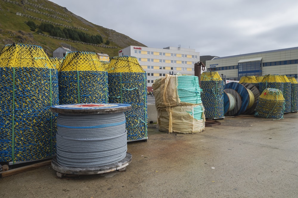 a pile of blue and yellow wire sitting next to a building