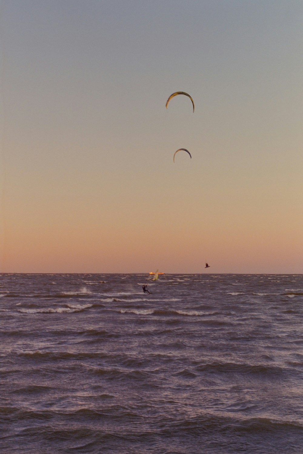 a couple of people para sailing in the ocean