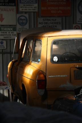 Close-up of a vintage VW Gol engine with parts scattered around in a dimly lit garage.