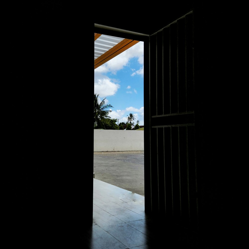 an open door leading into a parking lot