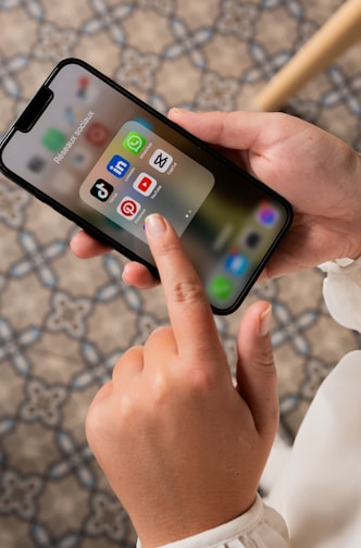 a person holding a cell phone in their hand