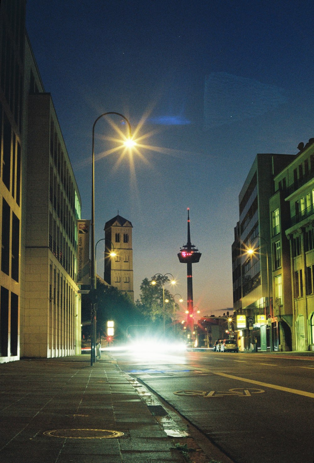 a city street at night with a street light