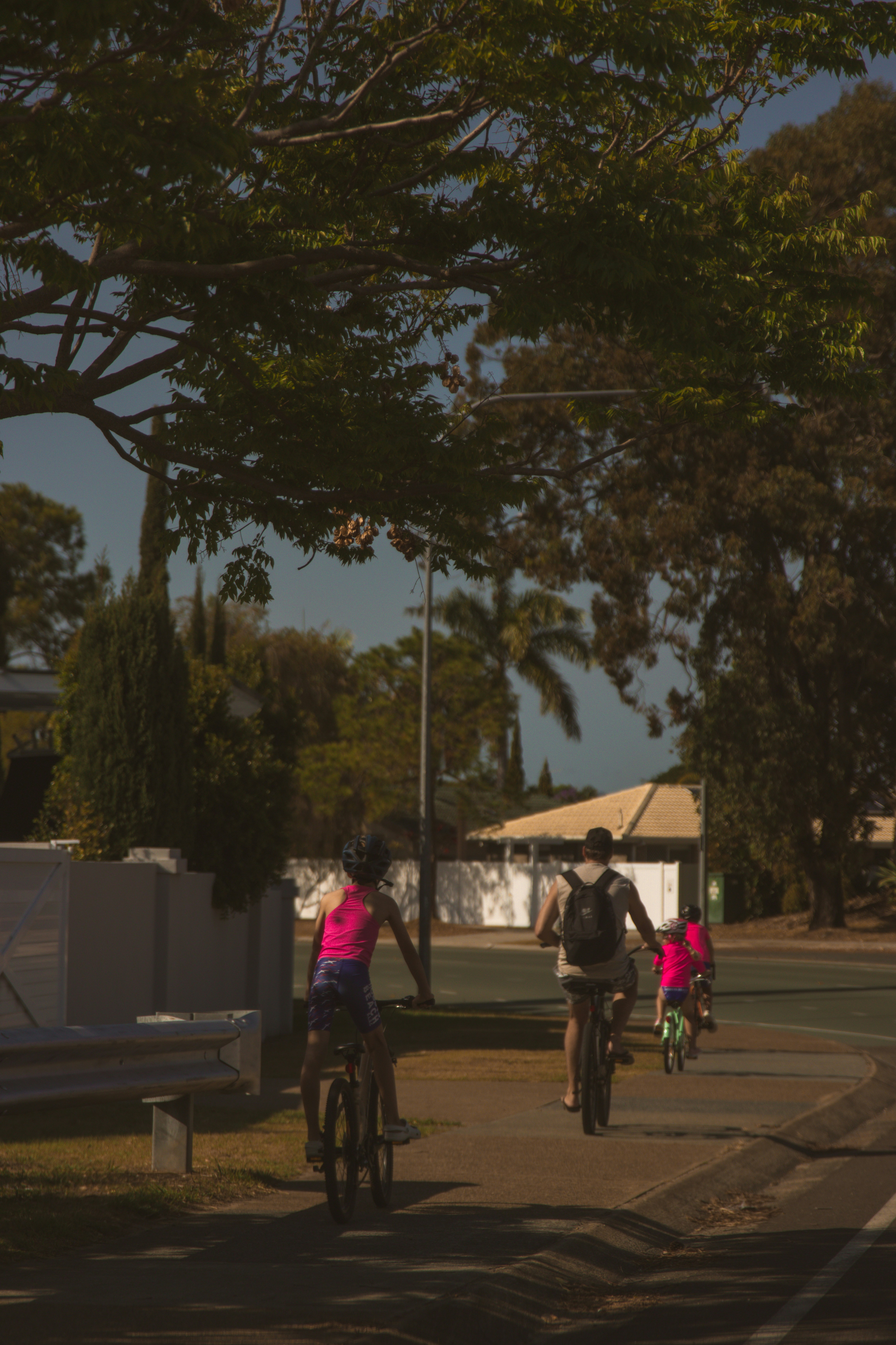 a group of people riding bikes down a street