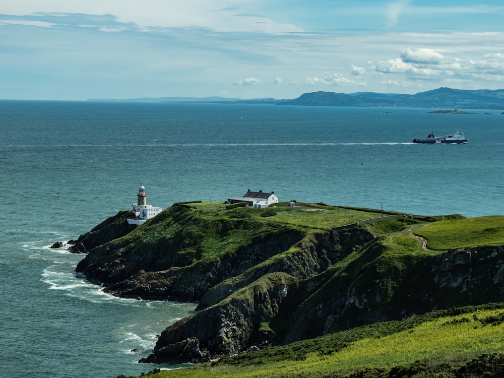 a boat is in the water near a lighthouse