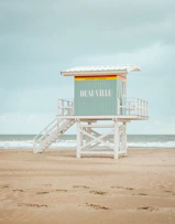 a lifeguard stand on the beach with a life guard on it