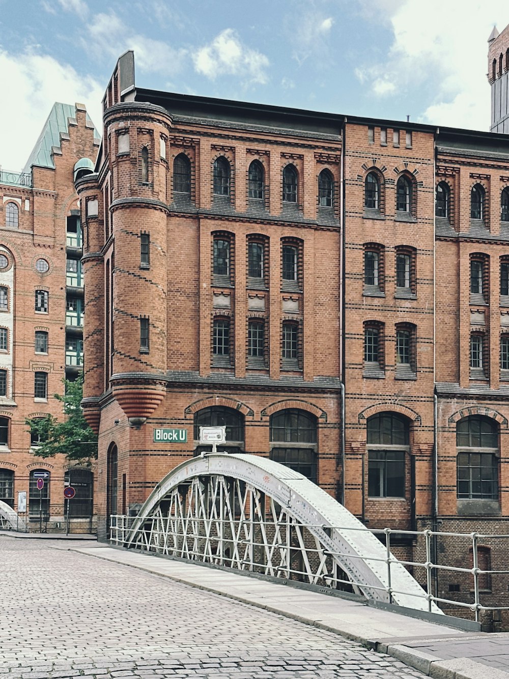 a large brick building with a bridge in front of it