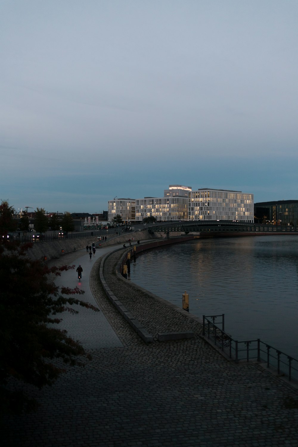 a large body of water with a building in the background