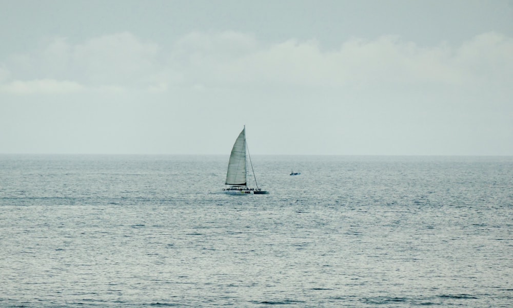 a sailboat in the middle of the ocean