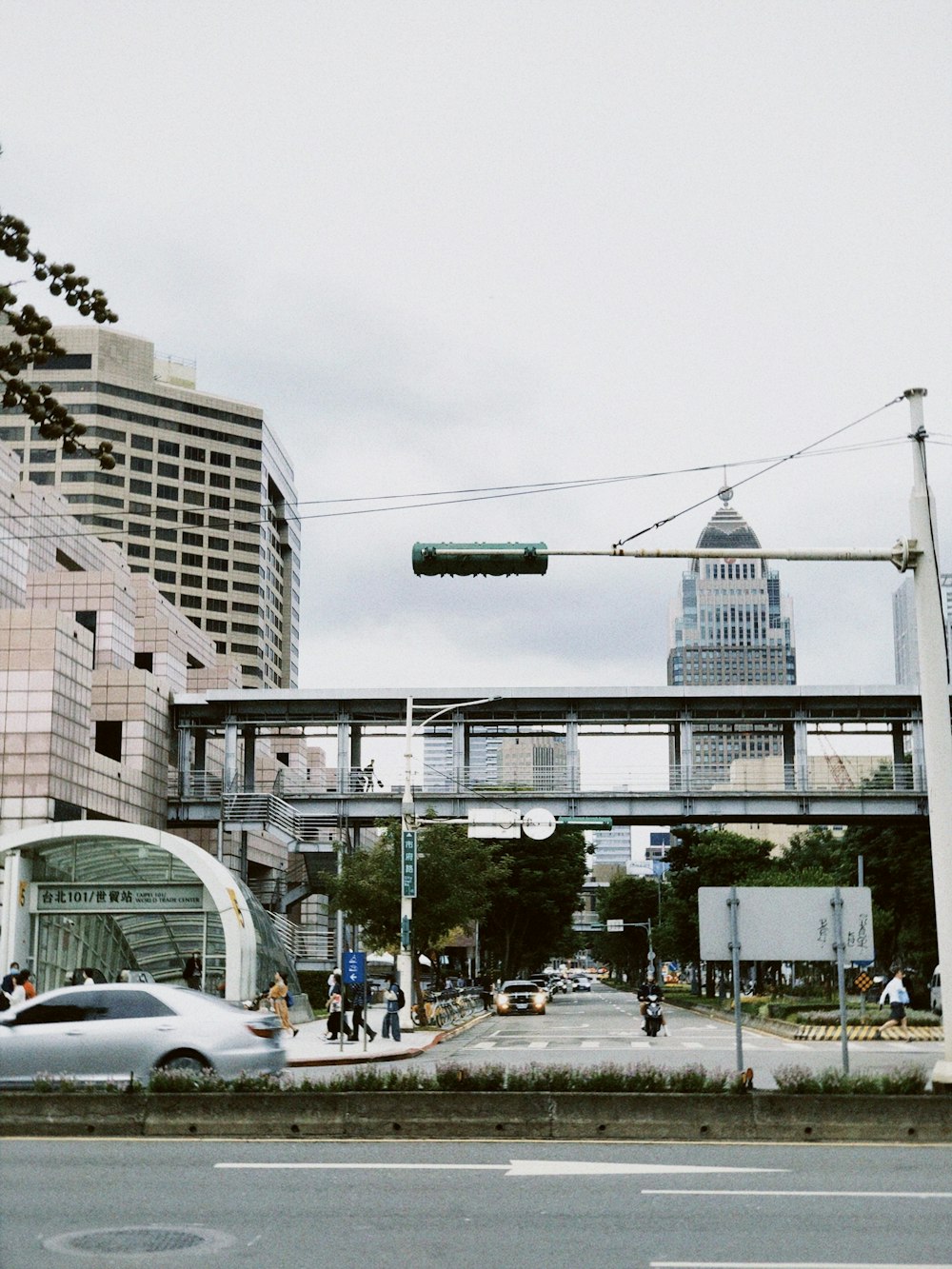 a city street with a bridge over it