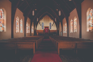 Interior view of the church sanctuary with warm liturgical colors and traditional Syriac crosses.