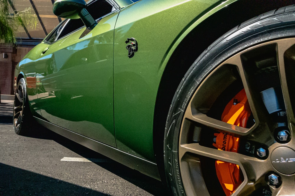 a green car parked on the side of the road