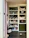 The image features a well-organized storage cabinet filled with a mixture of decorative items, jars, and plush toys. There are glass jars, some with plants, and plush toys resembling animals like reindeer and rabbits. Decorative spider webs are draped across the shelves, giving a hint of a Halloween theme. On one side, a basket and some colorful pet toys are placed on the lower shelves.