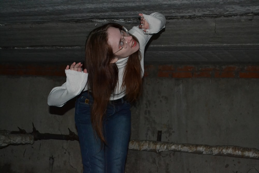 a woman with long red hair and a white shirt