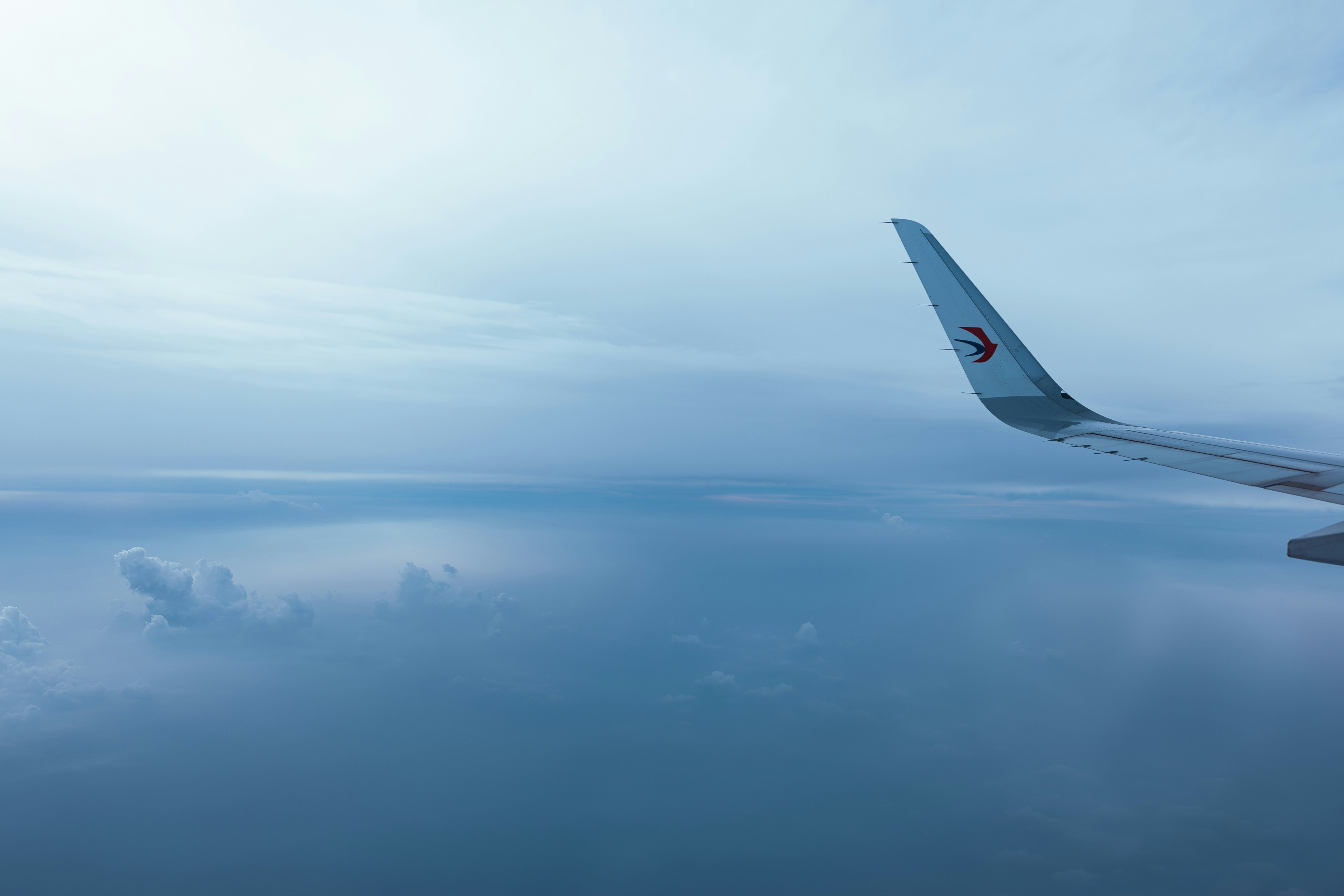 a view of the wing of an airplane in the sky, Special forms of clouds in the sky