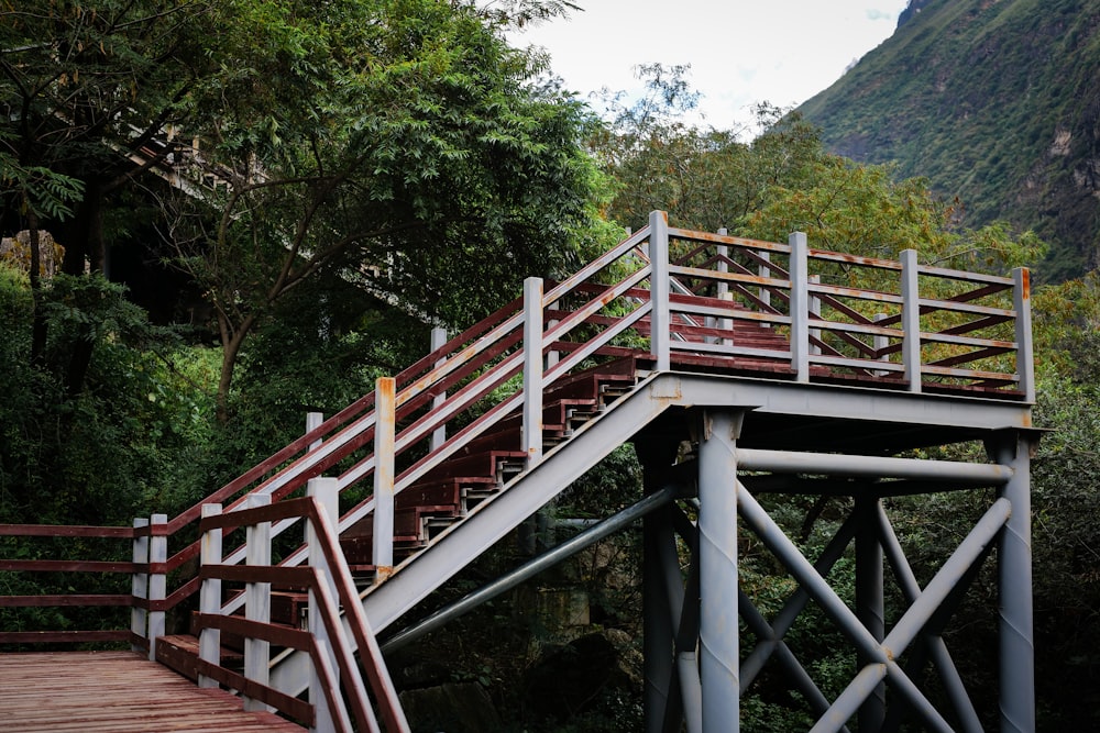 a wooden bridge with a metal hand rail
